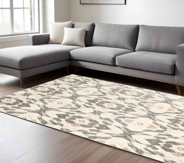 7' X 10' Ivory And Pink Geometric Distressed Area Rug