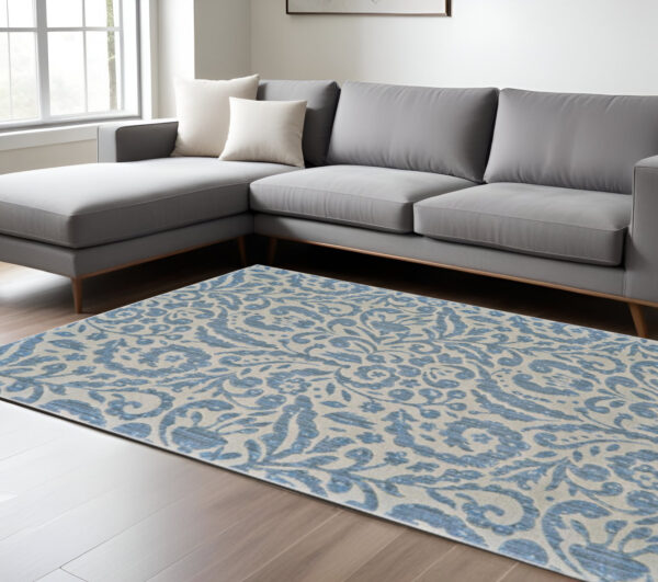 10' X 14' Blue Ivory And Tan Floral Distressed Stain Resistant Area Rug