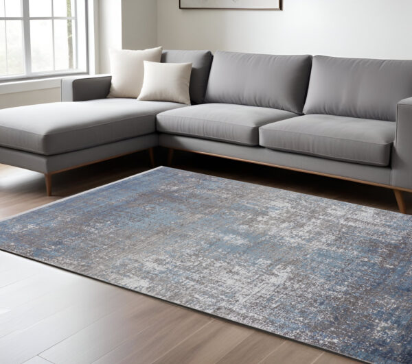 7' X 10' Blue and Gray Abstract Power Loom Distressed Area Rug With Fringe