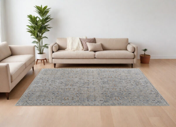 7' X 10' Ivory Tan and Blue Abstract Power Loom Worn Faded Area Rug With Fringe
