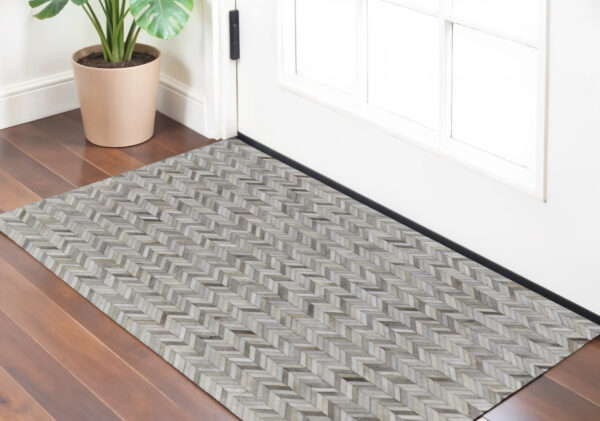 2' X 3' Gray Brown and Ivory Faux Cowhide Animal Print Power Loom Area Rug